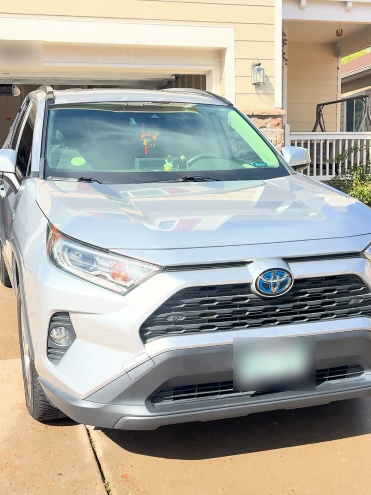 A silver Toyota RAV4, clean and dry after a detail in the driveway