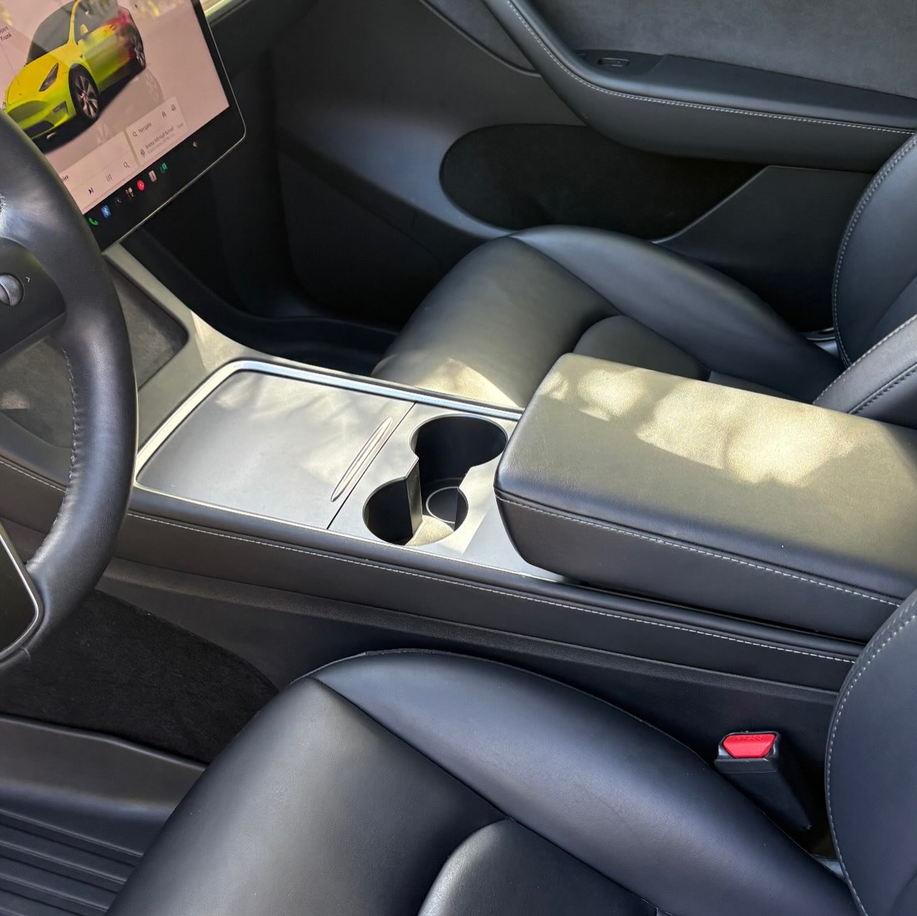 After: the Tesla's front seats and console, clean